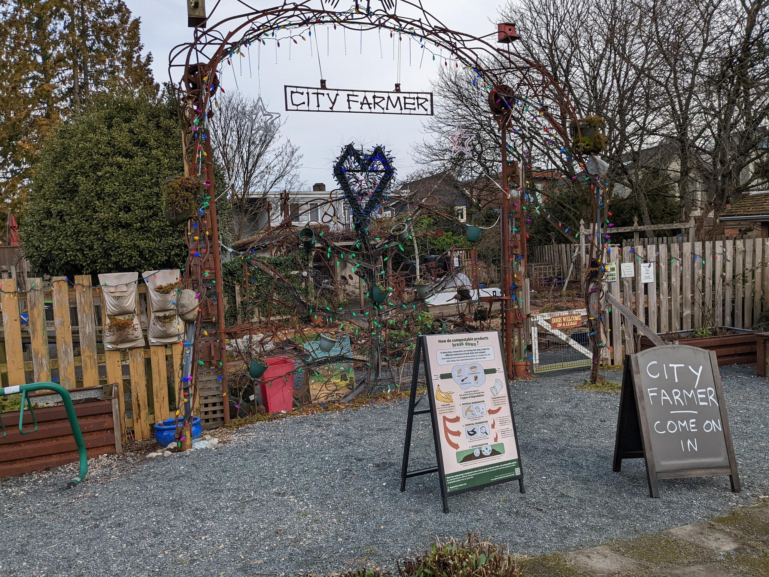 Signage outside the urban farm, along with a chalk sign: City Farmer